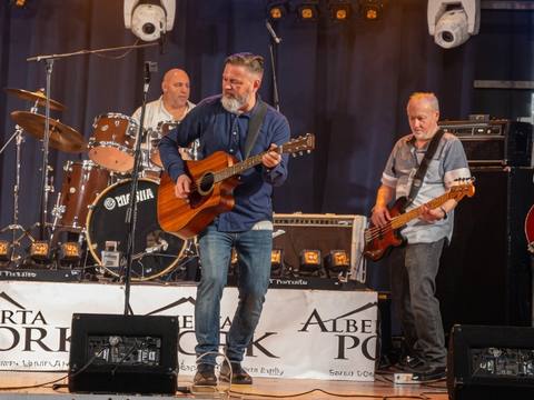 The Threads on stage at Edmonton Band-Aid with Alberta Pork banners, full band visible